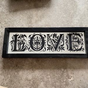 Black mirror with “LOVE” signage